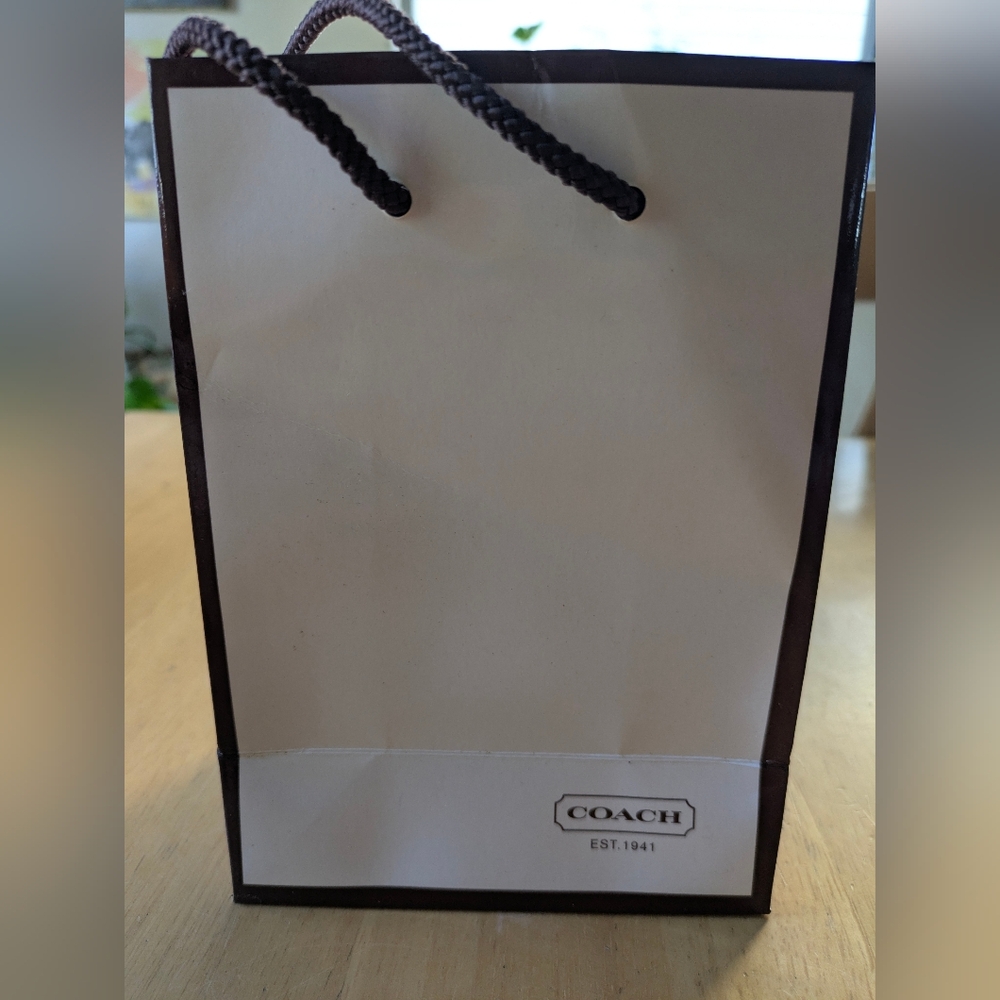 Coach, Glossy White Shopping Bag with Brown Cord Handles Red Inside, 2001.